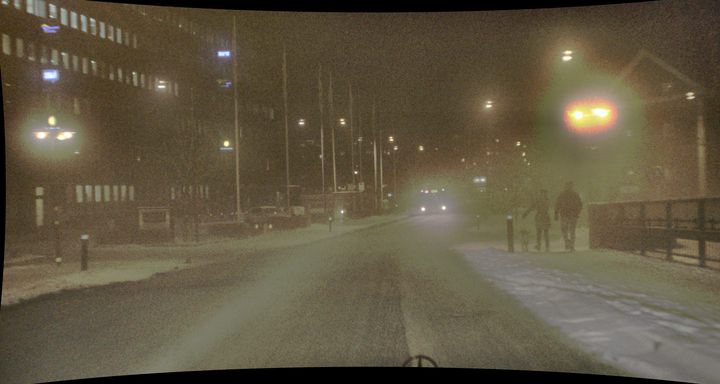 A night-time driving frame in fog and snow
